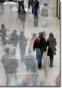 Crowd of shoppers in shopping mall. Two images overlaid to give ghosting effect. photo