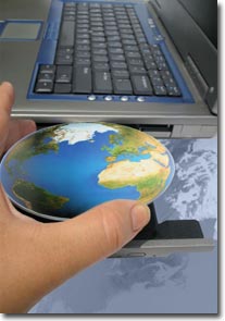 hand inserting the world into a computer photo